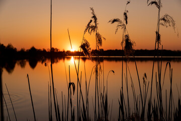 a beautiful reflection of the colorful sky in the water at sunset