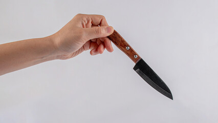 Hand and knife on a white background
