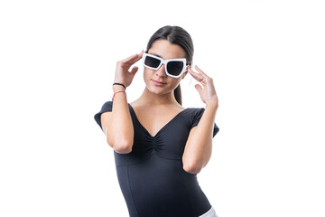 Studio portrait of young brunette model woman wearing funny fancy white sun glasses