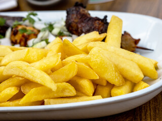 Fried potatoes with gravy and fried sausages