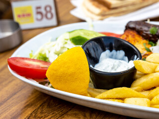 Fried potatoes with gravy and fried sausages