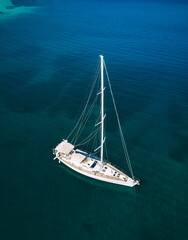 Aerial view of luxury yacht sailboat cruising in blue waters of Greece