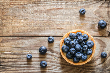Blueberry tart on a wooden background, top view, copy space.