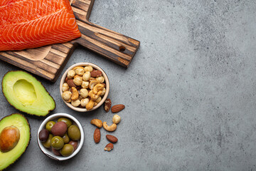Food sources of healthy unsaturated fat and omega 3: fresh raw salmon fillet, avocado, olives, nuts...