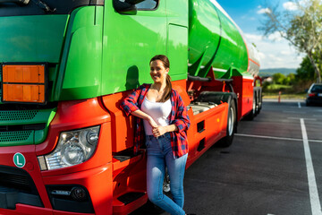 A young woman poses in front of her first cargo truck before embarking on a cross-country tour