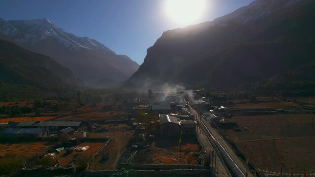 Aerial overhead fly over Humde village houses and lands property. Marshyangdi valley. Himalayas mountain range. Nepalese culture, lifestyle, community concept.
