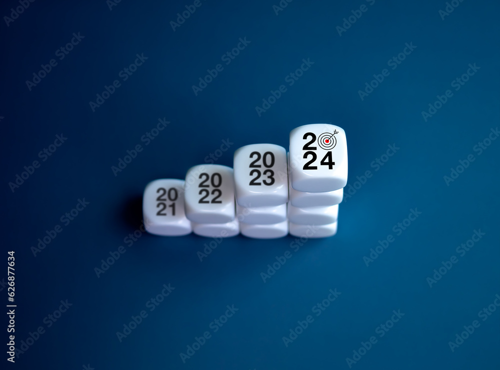 Poster 2024 year number with target icon on the top of white blocks as graph steps on blue background, top 