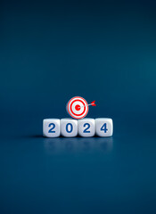 The calendar year 2024 with goal and success concept. 3d target icon on white cube blocks with...