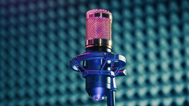 Professional microphone in the sound recording booth. Sound production concept.
