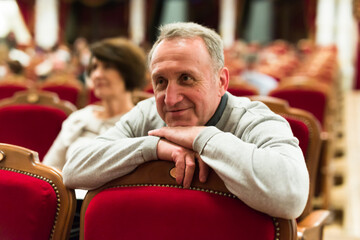 mature man watching play in the theater