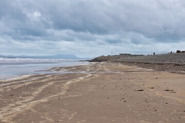 view of the beach with sand and  rocks