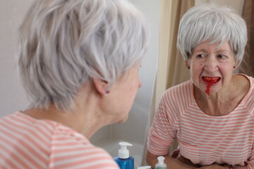 Worried senior woman vomiting blood 