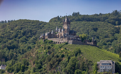The old German medieval castle with the name Reichsburg Cochem in the hills near the town of Cochem on the river named Mosel, in the state of Rheinland-Pfalz