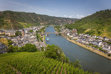 View on the German city of Cochem with the colored houses and the cruise and cargo ships in the river called Moselle,  state of Rheinland-Pfalz.
