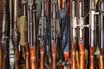 Automatic weapon collection, rifles and machine guns in gun cabinet - obrazy, fototapety, plakaty