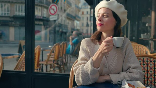 Happy girl with a cup of coffee in a restaurant in Paris