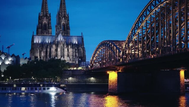 Cologne city night skyline, Germany. Rhine river, Hohenzollern bridge, and the Cathedral