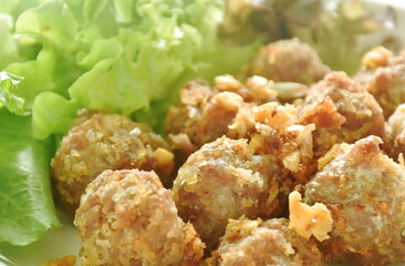 deep fried pork mixed glass noodles with fresh vegetable on plate