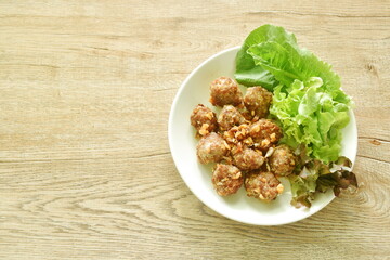 deep fried pork mixed glass noodles with fresh vegetable on plate