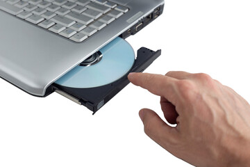 hand inserts dvd disc into laptop, concept of burning data to dvd on isolating background