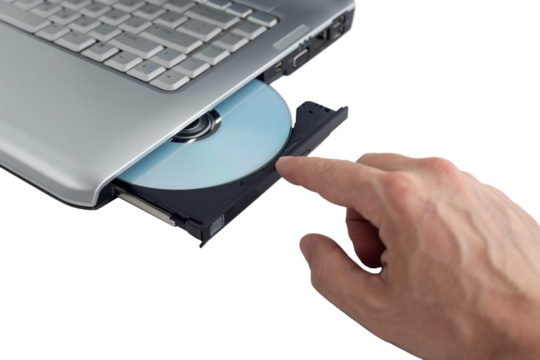 hand inserts dvd disc into laptop, concept of burning data to dvd on isolating background