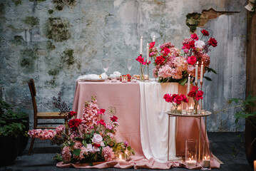 Table setting in restaurant. Location for surprise marriage proposal. Engagement. Decoration flowers, decor candles. Luxury romantic date. Candle light dinner setup table for couple on Valentines day.