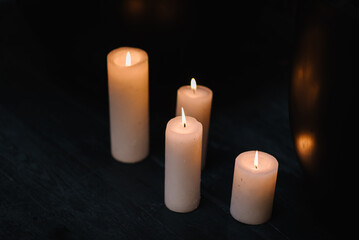 Fototapeta na wymiar Candles on floor. Decoration on black background, decor candles, details closeup. Luxury romantic date. Location for surprise marriage proposal in restaurant. Candlelight for couple on Valentines day