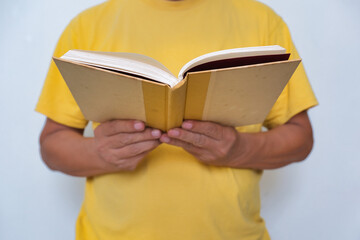 Close-up: Male's hands holding a book