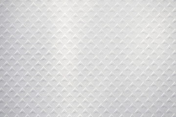 Embossed white paper with a diamond pattern. Rhombus stamped paper. Top view