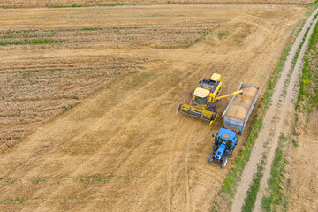 Combine harvester and a tractor working