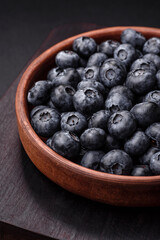Delicious fresh sweet blueberries in a ceramic bowl. Vegan food