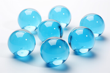 Decorative round glass blue balls marbles on white background.