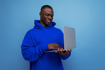 handsome successful african young businessman with portable laptop on background with copy space