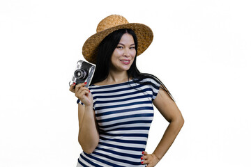 Young asian woman in straw hat is posing with a vintage photo camera. Isolated on white.
