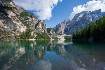 Fototapeta na wymiar The lake is clear, sometimes green, sometimes blue, and surrounded by mountains. Nature's Wonderland: Lake Braies and its Captivating Alpine Scenery.
