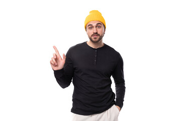 smart authentic brunet male adult in a black sweater talks about an idea on a white background with copy space