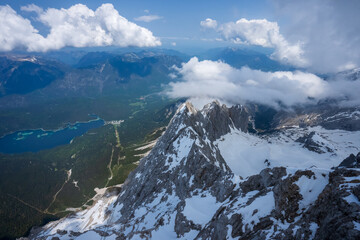 The view from the cable car. Lake, Mountain, Blue sky, white clouds, snow. The Zugspitze belongs to...