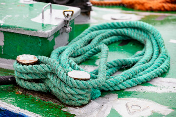 Coiled mooring line on the deck of a fishing boat. © Piotr