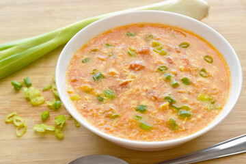 Tomato egg drop soup in a white bowl. Traditional Chinese food.