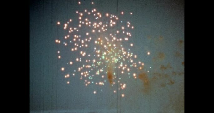 Celebration firework in night sky background. colorful fireworks explosion in party event. Fire light show festival. New year celebrate. Archival vintage color film. Archive video. Old retro 1980s