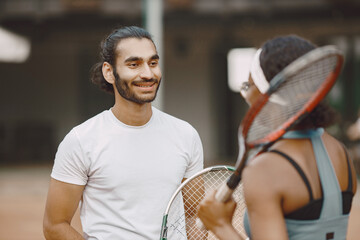 Two tennis players talking on a tennis court before the match