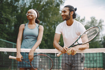 Two tennis players talking on a tennis court before the match - Powered by Adobe