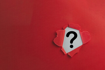 Fototapeta Problem,Confusion,Answer,Decisions,Sign and Symbol,FAQ concept.,Black Question Mark icon in Breakthrough red paper hole with white background. obraz
