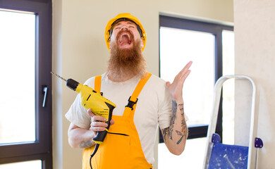 red hair man screaming with hands up in the air repairing home. handyman concept