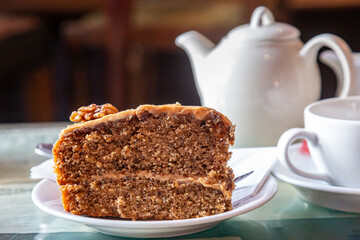 A slice of coffee and walnut cake, with a shallow depth of field