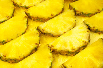 Pineapple juicy yellow slices as a background.