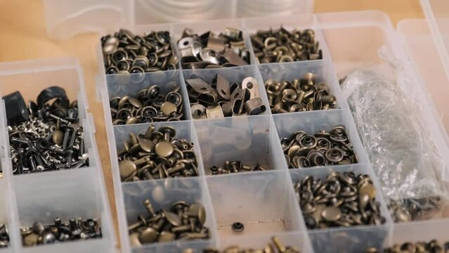 High angle view of eyelets for leather crafting in workshop