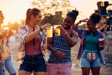 Cheerful festival goers have fun while toasting with beer.