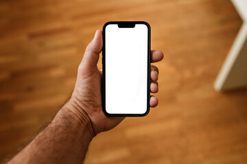 Mobile phone mockup with blank white screen in male hand, personal pov image