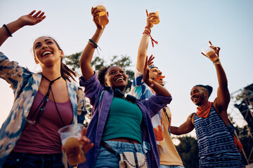 Below view of happy festival goers enjoy in music concert during summer.